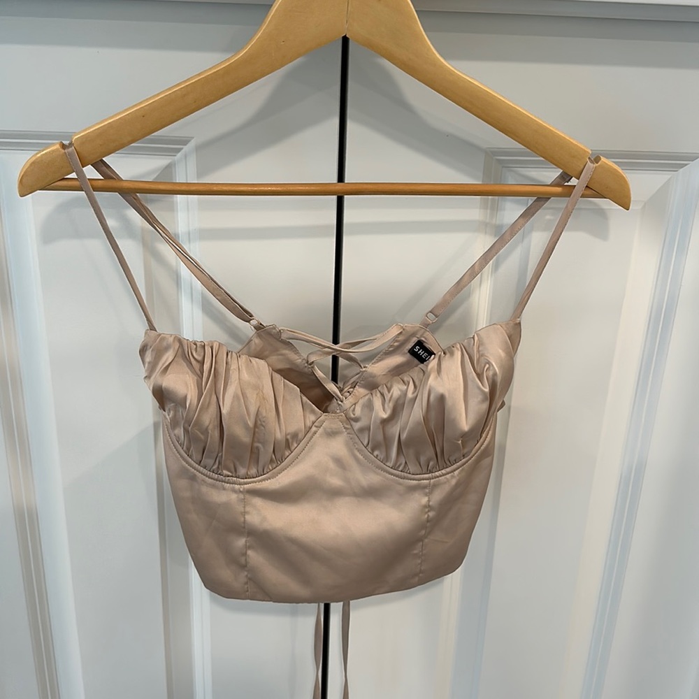 Crop top featuring adjustable straps and cinch drawstring cross cross back.